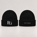 Design mockup: black beanie with white interlocking B&G monogram on the front and slim EST.2026 lettering on the back
