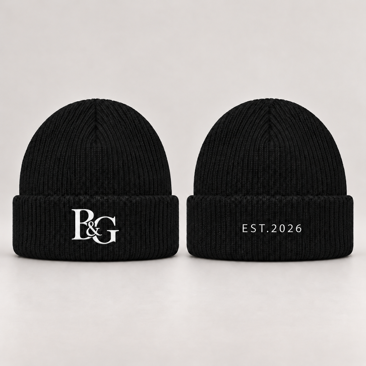 Design mockup: black beanie with white interlocking B&G monogram on the front and slim EST.2026 lettering on the back