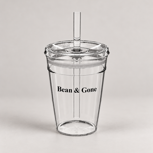 Bean & Gone Reusable Iced Coffee Cup — Black 12oz with Hard Plastic Straw on a warm grey background