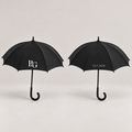 Two views of the same umbrella showing the white B&G monogram and EST.2026 on opposite sides. Design mockup; sold individually.